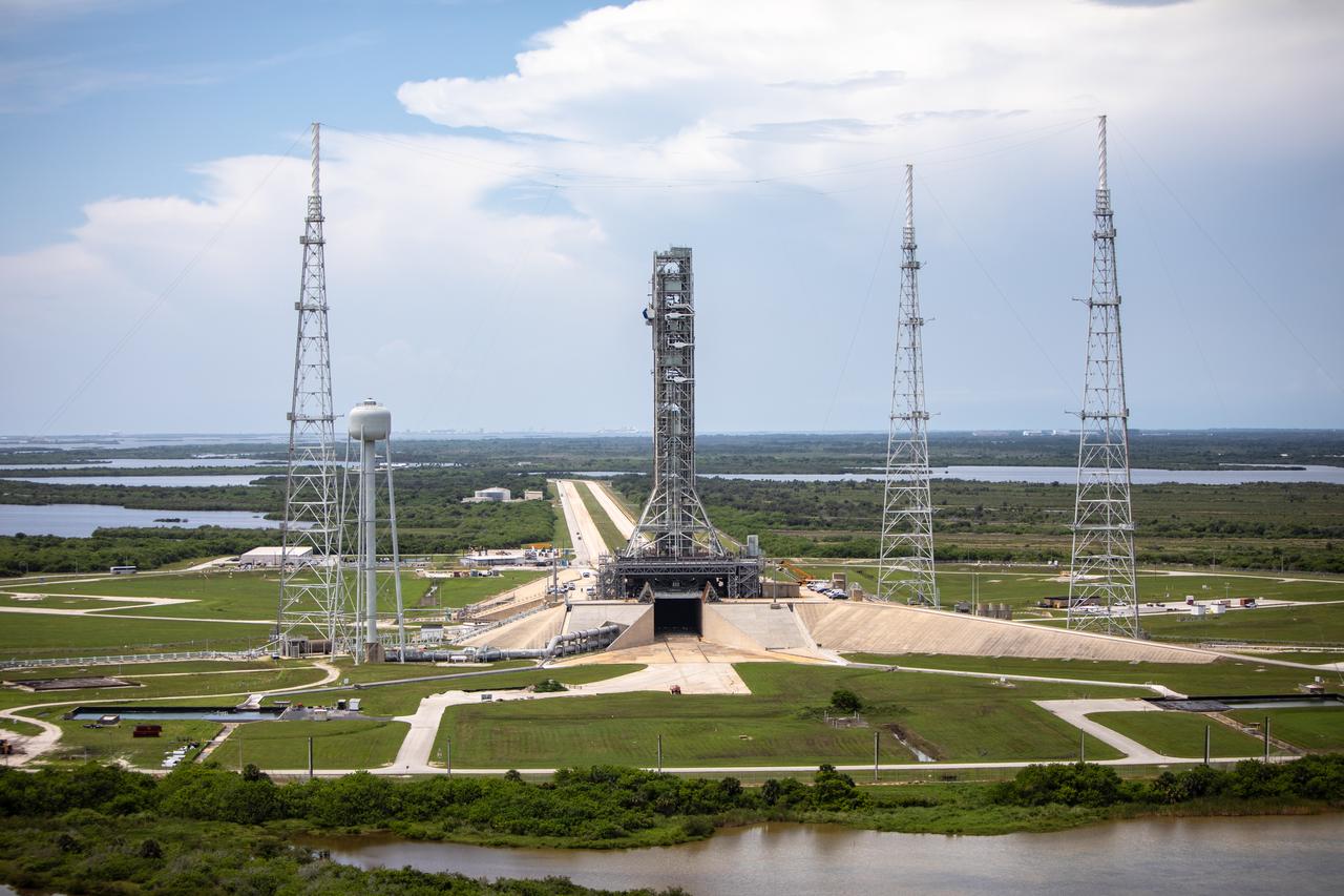 An aerial view of Launch Complex 39B with Exploration Ground Systems’ mobile launcher for the Artemis 1 mission on the pad. The mobile launcher, atop crawler-transporter 2, made its final solo trek from the Vehicle Assembly Building on June 27, 2019, and arrived on the surface of pad B on June 28, 2019, at NASA’s Kennedy Space Center in Florida. The mobile launcher will remain at the pad over the summer, undergoing final testing and checkouts. Its next roll to the pad will be with the agency’s Space Launch System rocket and Orion spacecraft in preparation for the launch of Artemis 1.