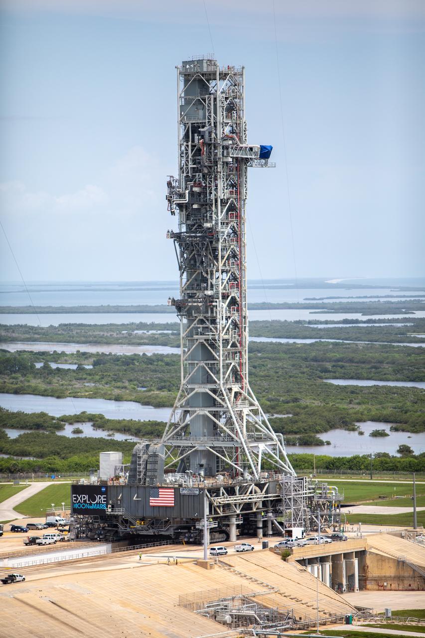 A close-up aerial view of Launch Complex 39B with Exploration Ground Systems’ mobile launcher for the Artemis 1 mission on the pad. The mobile launcher, atop crawler-transporter 2, made its final solo trek from the Vehicle Assembly Building on June 27, 2019, and arrived on the surface of pad B on June 28, 2019, at NASA’s Kennedy Space Center in Florida. The mobile launcher will remain at the pad over the summer, undergoing final testing and checkouts. Its next roll to the pad will be with the agency’s Space Launch System rocket and Orion spacecraft in preparation for the launch of Artemis 1.