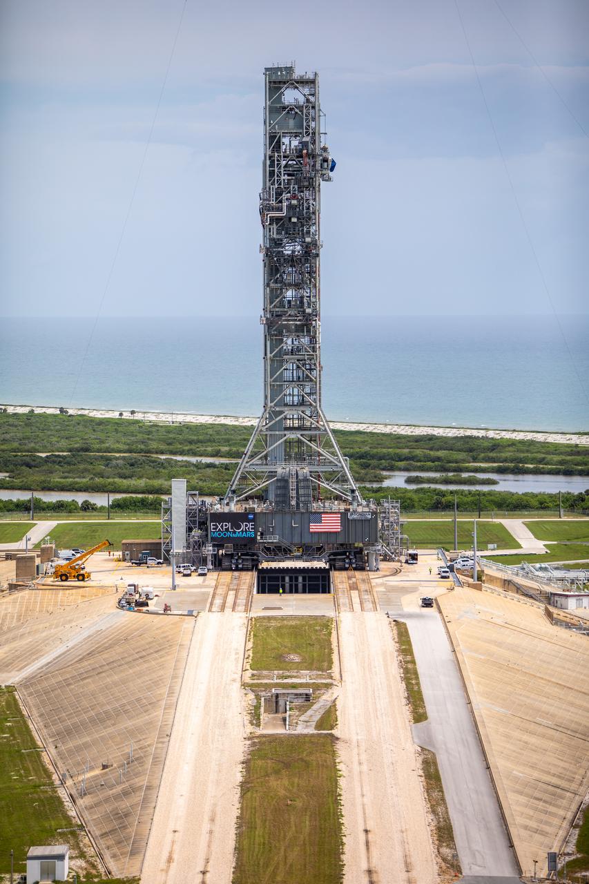 A close-up aerial view of Launch Complex 39B with Exploration Ground Systems’ mobile launcher for the Artemis 1 mission on the pad. The mobile launcher, atop crawler-transporter 2, made its final solo trek from the Vehicle Assembly Building on June 27, 2019, and arrived on the surface of pad B on June 28, 2019, at NASA’s Kennedy Space Center in Florida. The mobile launcher will remain at the pad over the summer, undergoing final testing and checkouts. Its next roll to the pad will be with the agency’s Space Launch System rocket and Orion spacecraft in preparation for the launch of Artemis 1.