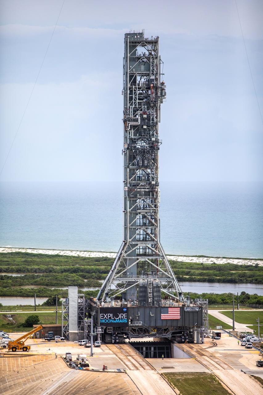 A close-up aerial view of Launch Complex 39B with Exploration Ground Systems’ mobile launcher for the Artemis 1 mission on the pad. The mobile launcher, atop crawler-transporter 2, made its final solo trek from the Vehicle Assembly Building on June 27, 2019, and arrived on the surface of pad B on June 28, 2019, at NASA’s Kennedy Space Center in Florida. The mobile launcher will remain at the pad over the summer, undergoing final testing and checkouts. Its next roll to the pad will be with the agency’s Space Launch System rocket and Orion spacecraft in preparation for the launch of Artemis 1.