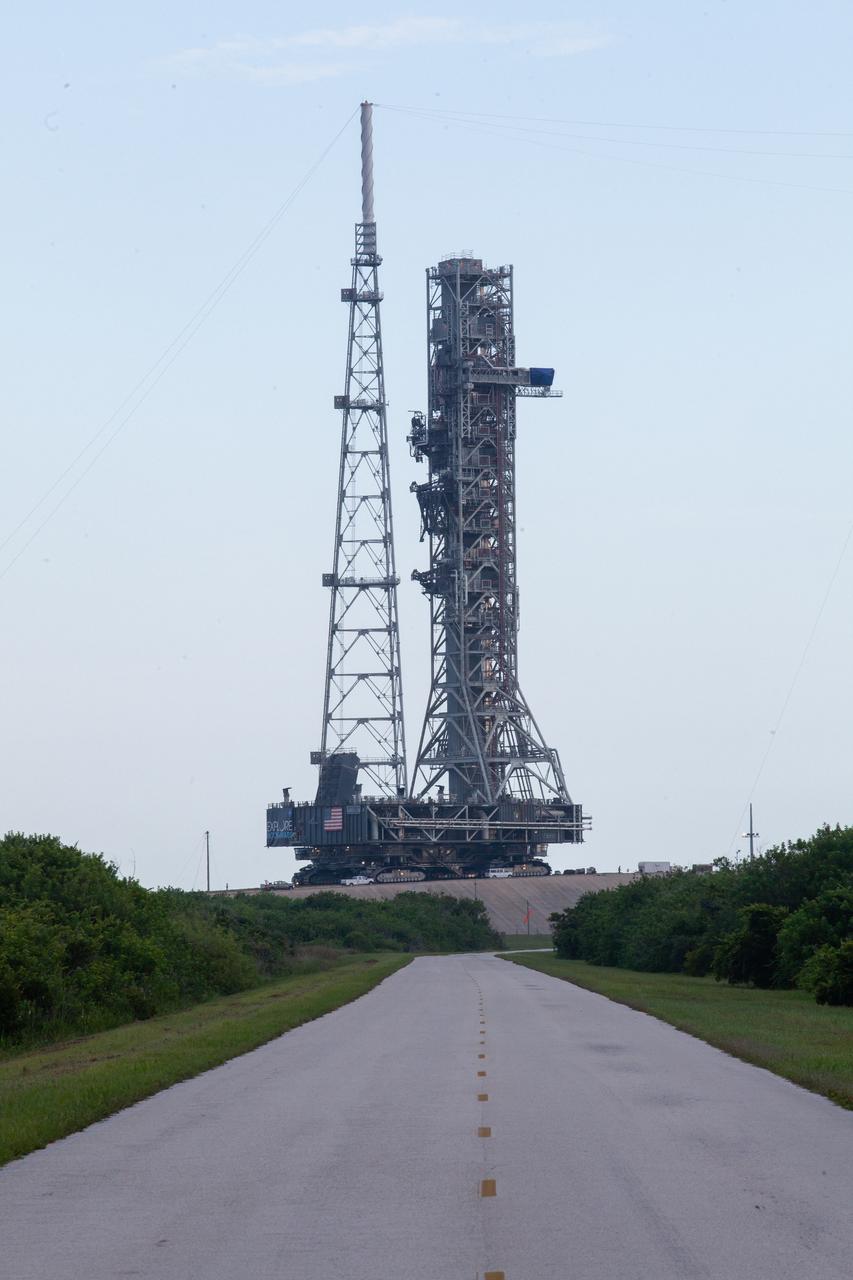 After successfully arriving at Kennedy Space Center’s Launch Complex 39B, Exploration Ground Systems’ mobile launcher is photographed at the pad surface atop crawler-transporter 2 on June 28, 2019. The mobile launcher began its final solo trek to the pad at midnight on June 27, departing from NASA’s Vehicle Assembly Building. The mobile launcher will remain at the pad over the summer, undergoing final testing and checkouts. Its next roll to the pad will be with the agency’s Space Launch System rocket and Orion in preparation for the launch of Artemis 1.