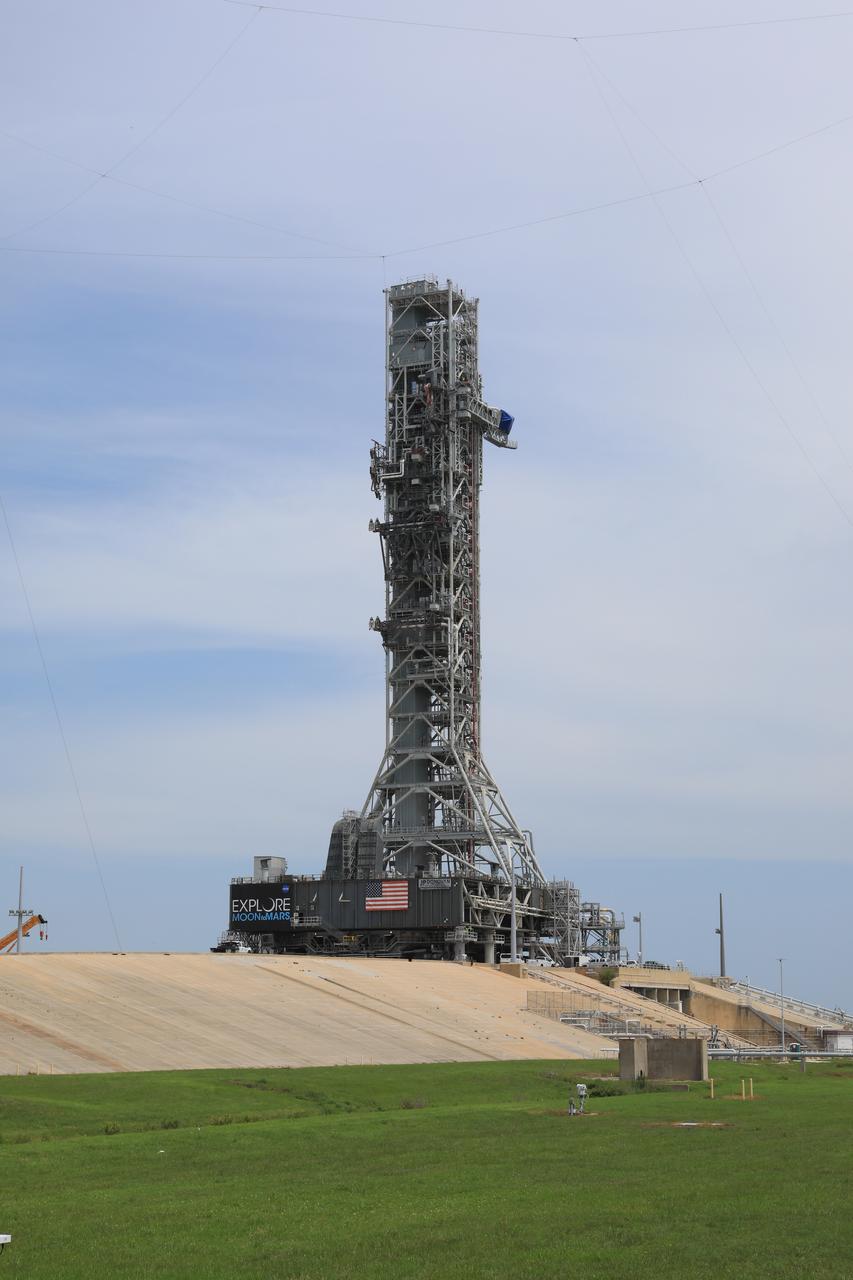 After successfully arriving at Kennedy Space Center’s Launch Complex 39B, Exploration Ground Systems’ mobile launcher is photographed at the pad surface on June 28, 2019. The mobile launcher began its final solo trek to the pad at midnight on June 27, departing from NASA’s Vehicle Assembly Building. The mobile launcher will remain at the pad over the summer, undergoing final testing and checkouts. Its next roll to the pad will be with the agency’s Space Launch System rocket and Orion in preparation for the launch of Artemis 1.