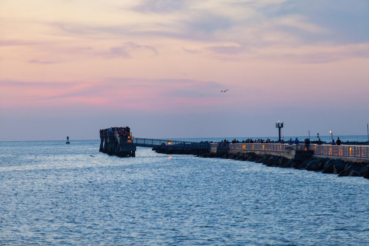 A view of Jetty Park in Cape Canaveral, Florida, on July 2, 2019, as crowds gather to watch a Northrop Grumman provided booster launch from Launch Pad 46 carrying a fully functional Launch Abort System with a test version of Orion attached for NASA’s Ascent Abort-2 (AA-2). Launch time was 7 a.m. EDT. During AA-2, the booster will send the LAS and Orion to an altitude of 31,000 feet, traveling at Mach 1.15 (more than 1,000 mph). The LAS’ three motors will work together to pull the crew module away from the booster and prepare it for splashdown in the Atlantic Ocean. The flight test will prove that the abort system can pull crew to safety in the unlikely event of an emergency during ascent.