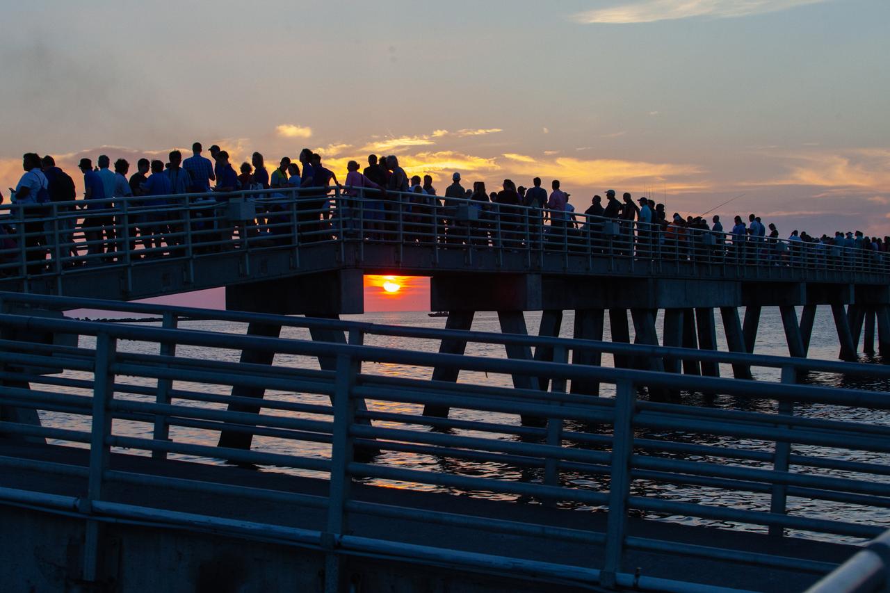 Crowds of spectators watch from Jetty Park in Cape Canaveral, Florida, on July 2, 2019, as a Northrop Grumman provided booster launches from Launch Pad 46 carrying, a fully functional Launch Abort System with a test version of Orion attached for NASA’s Ascent Abort-2 (AA-2). Launch time was 7 a.m. EDT. During AA-2, the booster will send the LAS and Orion to an altitude of 31,000 feet, traveling at Mach 1.15 (more than 1,000 mph). The LAS’ three motors will work together to pull the crew module away from the booster and prepare it for splashdown in the Atlantic Ocean. The flight test will prove that the abort system can pull crew to safety in the unlikely event of an emergency during ascent.