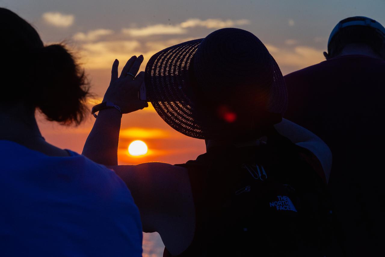 Crowds of spectators watch from Jetty Park in Cape Canaveral, Florida, on July 2, 2019, as a Northrop Grumman provided booster launches from Launch Pad 46 carrying, a fully functional Launch Abort System with a test version of Orion attached for NASA’s Ascent Abort-2 (AA-2). Launch time was 7 a.m. EDT. During AA-2, the booster will send the LAS and Orion to an altitude of 31,000 feet, traveling at Mach 1.15 (more than 1,000 mph). The LAS’ three motors will work together to pull the crew module away from the booster and prepare it for splashdown in the Atlantic Ocean. The flight test will prove that the abort system can pull crew to safety in the unlikely event of an emergency during ascent.