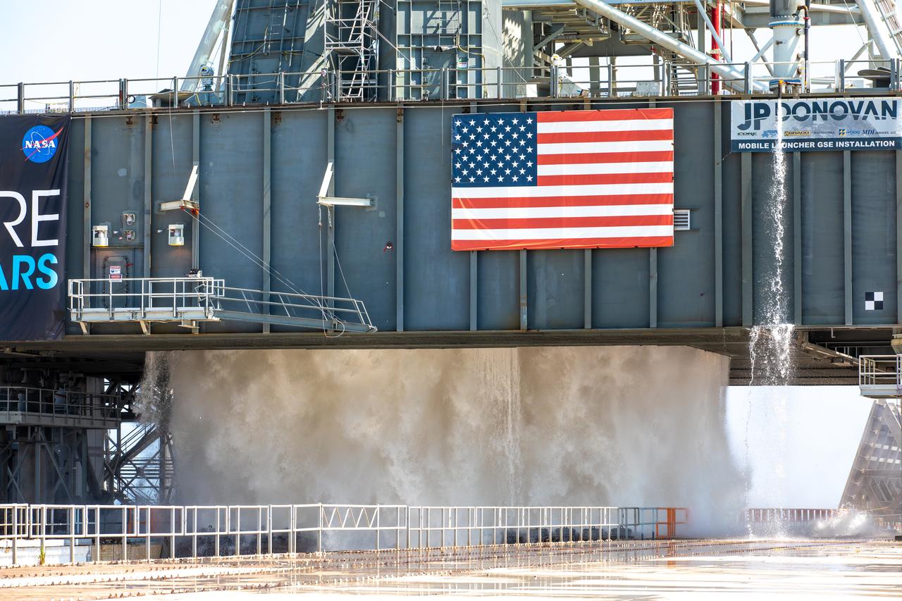 NASA’s Exploration Ground Systems conducts a water flow test with the mobile launcher at Kennedy Space Center’s Pad 39B in Florida on July 2, 2019. It is the first of nine tests to verify the sound suppression system is ready for launch of NASA’s Space Launch System for the first Artemis mission. During launch, 400,000 gallons of water will rush onto the pad to help protect the rocket, NASA’s Orion Spacecraft, mobile launcher, and launch pad from the extreme acoustic and temperature environment.