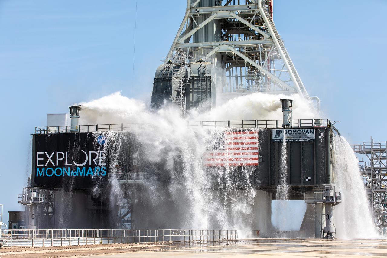 NASA’s Exploration Ground Systems conducts a water flow test with the mobile launcher at Kennedy Space Center’s Pad 39B in Florida on July 2, 2019. It is the first of nine tests to verify the sound suppression system is ready for launch of NASA’s Space Launch System for the first Artemis mission. During launch, 400,000 gallons of water will rush onto the pad to help protect the rocket, NASA’s Orion Spacecraft, mobile launcher, and launch pad from the extreme acoustic and temperature environment.