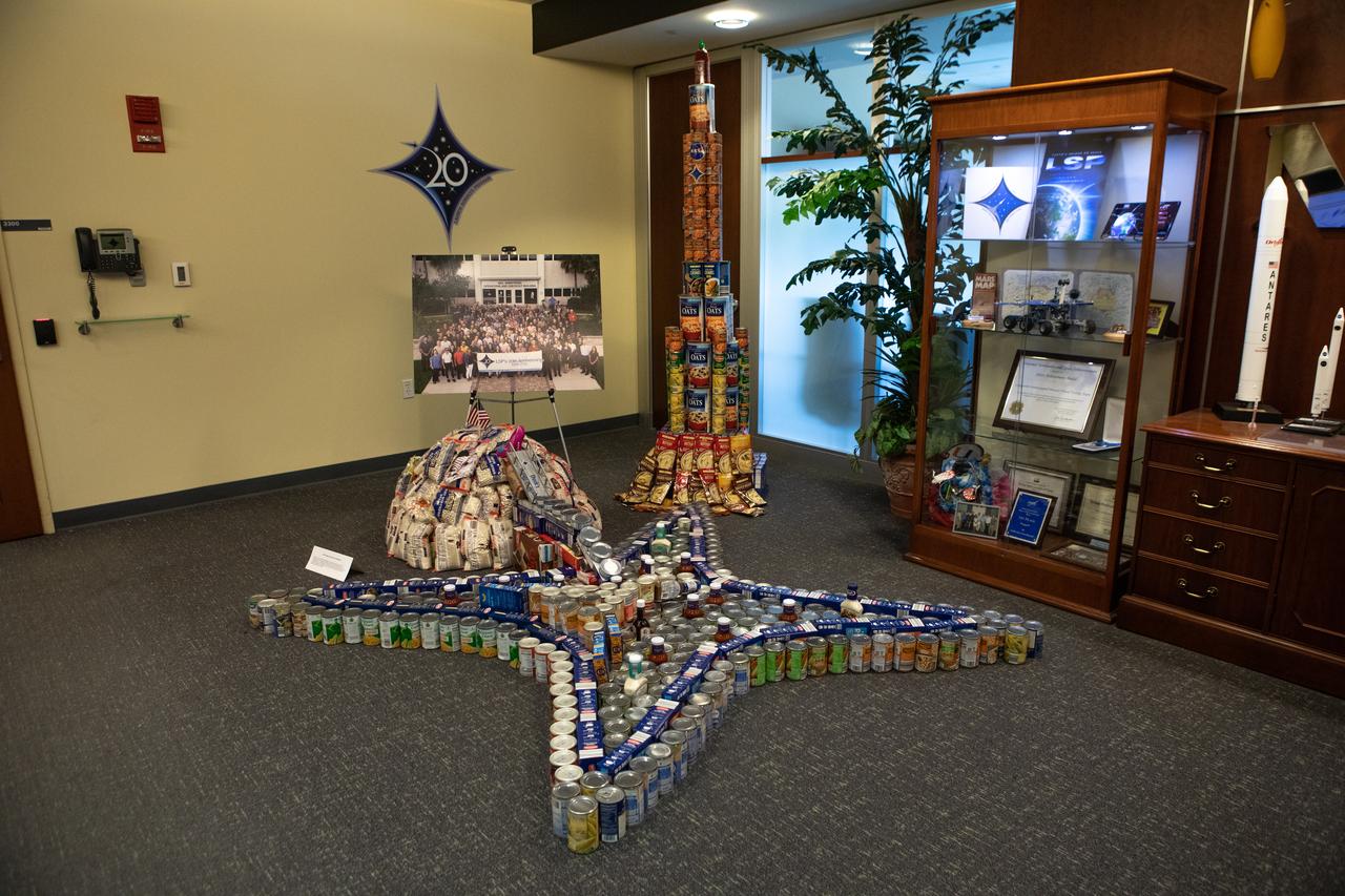 A sculpture created out of non-perishable canned and boxed foods by NASA’s Launch Services Program is on display at Kennedy Space Center in Florida as part of the 2019 Feds Feeds Families campaign. Kennedy employees had the opportunity to work in teams to construct sculptures reflecting this year’s theme – The Moon Lights the Way – to pay tribute to the 50th anniversary of the first Apollo Moon landing. As part of the theme, the can sculptures highlighted the accomplishments of the Apollo Program while incorporating aspects of NASA’s aim to return to the Moon and beyond to Mars. On Aug. 2, 2019, all sculptures will be deconstructed and boxed for donation.