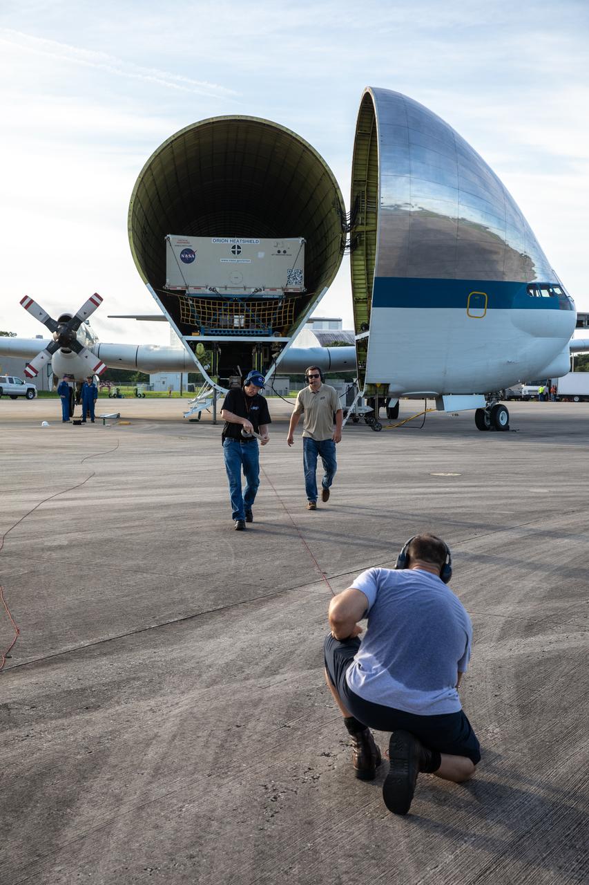 The heat shield for Orion’s Artemis 2 mission, NASA’s first crewed mission, arrives in its shipping container aboard NASA’s Super Guppy aircraft at the agency’s Kennedy Space Center Shuttle Landing Facility in Florida on July 9, 2019. The heat shield, measuring roughly 16 feet in diameter, will protect astronauts upon re-entry on the second mission of Artemis. The heat shield arrived from Lockheed Martin’s manufacturing facility near Denver. It will be offloaded and delivered to the Neil Armstrong Operations and Checkout facility high bay. The heat shield is a base titanium truss structure. Over the next several months, technicians will apply Avcoat, an ablative material that will provide the thermal protection. Artemis 2 will confirm all of the spacecraft’s systems operate as designed in the actual environment of deep space with astronauts aboard.