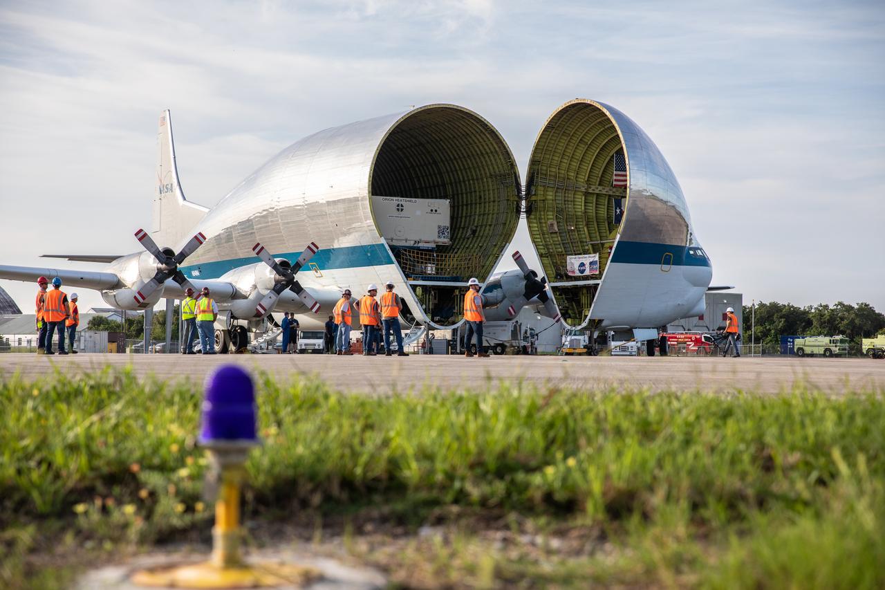 The heat shield for Orion’s Artemis 2 mission, NASA’s first crewed mission, arrives in its shipping container aboard NASA’s Super Guppy aircraft at the agency’s Kennedy Space Center Shuttle Landing Facility in Florida on July 9, 2019. The heat shield, measuring roughly 16 feet in diameter, will protect astronauts upon re-entry on the second mission of Artemis. The heat shield arrived from Lockheed Martin’s manufacturing facility near Denver. It will be offloaded and delivered to the Neil Armstrong Operations and Checkout facility high bay. The heat shield is a base titanium truss structure. Over the next several months, technicians will apply Avcoat, an ablative material that will provide the thermal protection. Artemis 2 will confirm all of the spacecraft’s systems operate as designed in the actual environment of deep space with astronauts aboard.