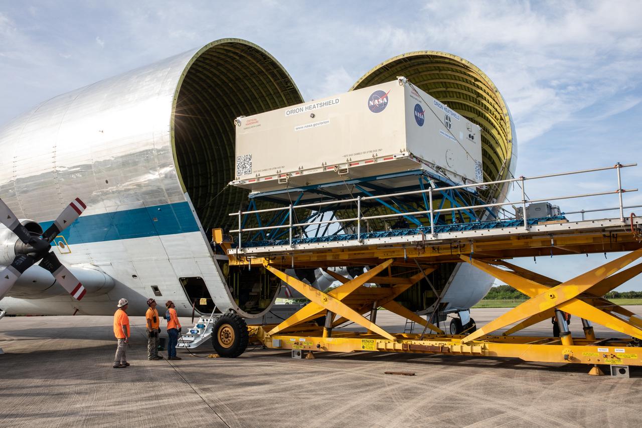 The shipping container carrying the heat shield for Orion’s Artemis 2 mission, NASA’s first crewed mission, is unloaded from NASA’s Super Guppy aircraft at the agency’s Kennedy Space Center Shuttle Landing Facility in Florida on July 9, 2019. The heat shield, measuring roughly 16 feet in diameter, will protect astronauts upon re-entry on the second mission of Artemis. The heat shield arrived from Lockheed Martin’s manufacturing facility near Denver. It will be delivered to the Neil Armstrong Operations and Checkout facility high bay. The heat shield is a base titanium truss structure. Over the next several months, technicians will apply Avcoat, an ablative material that will provide the thermal protection. Artemis 2 will confirm all of the spacecraft’s systems operate as designed in the actual environment of deep space with astronauts aboard.