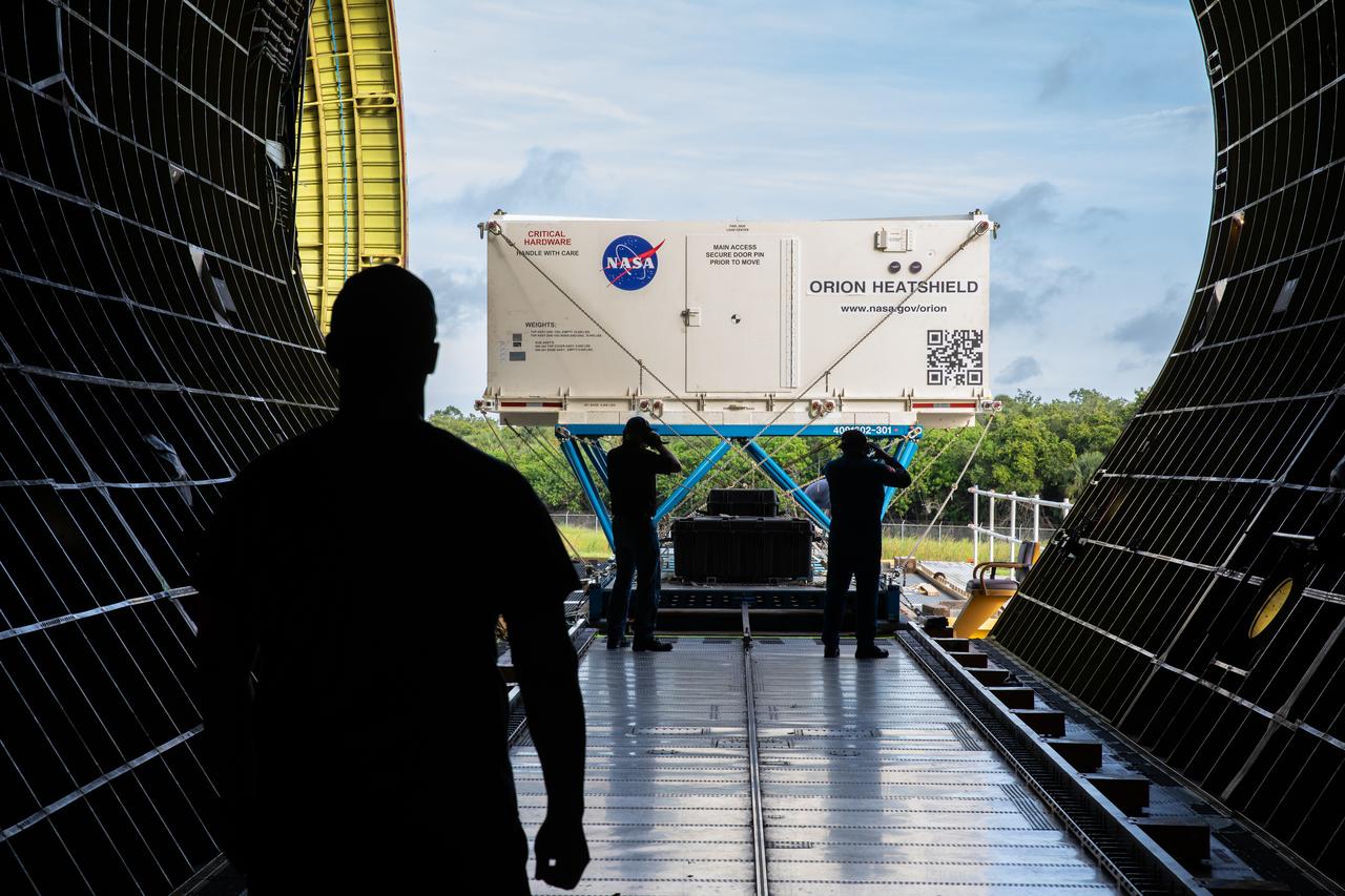 In this view from inside NASA’s Super Guppy aircraft, the shipping container carrying the heat shield for Orion’s Artemis 2 mission, NASA’s first crewed mission, is unloaded from NASA’s Super Guppy aircraft at the agency’s Kennedy Space Center Shuttle Landing Facility in Florida on July 9, 2019. The heat shield, measuring roughly 16 feet in diameter, will protect astronauts upon re-entry on the second mission of Artemis. The heat shield arrived from Lockheed Martin’s manufacturing facility near Denver. It will be delivered to the Neil Armstrong Operations and Checkout facility high bay. The heat shield is a base titanium truss structure. Over the next several months, technicians will apply Avcoat, an ablative material that will provide the thermal protection. Artemis 2 will confirm all of the spacecraft’s systems operate as designed in the actual environment of deep space with astronauts aboard.