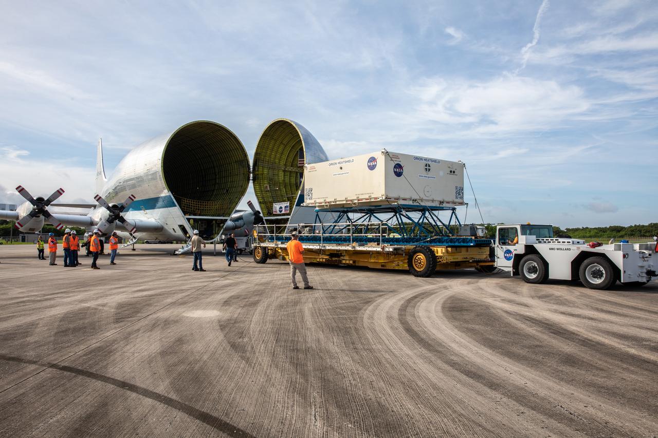 The shipping container carrying the heat shield for Orion’s Artemis 2 mission, NASA’s first crewed mission, is unloaded from NASA’s Super Guppy aircraft at the agency’s Kennedy Space Center Shuttle Landing Facility in Florida on July 9, 2019. The heat shield, measuring roughly 16 feet in diameter, will protect astronauts upon re-entry on the second mission of Artemis. The heat shield arrived from Lockheed Martin’s manufacturing facility near Denver. It will be delivered to the Neil Armstrong Operations and Checkout facility high bay. The heat shield is a base titanium truss structure. Over the next several months, technicians will apply Avcoat, an ablative material that will provide the thermal protection. Artemis 2 will confirm all of the spacecraft’s systems operate as designed in the actual environment of deep space with astronauts aboard.