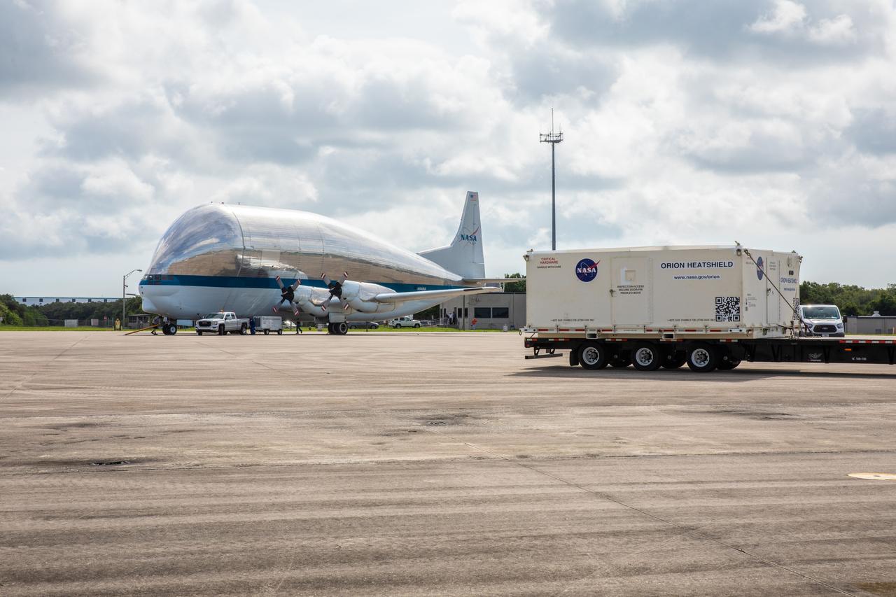 The shipping container carrying the heat shield for Orion’s Artemis 2 mission, NASA’s first crewed mission, is secured on a flatbed truck at the agency’s Kennedy Space Center Shuttle Landing Facility in Florida on July 9, 2019. The heat shield, measuring roughly 16 feet in diameter, will protect astronauts upon re-entry on the second mission of Artemis. The heat shield arrived from Lockheed Martin’s manufacturing facility near Denver aboard NASA’s Super Guppy Aircraft. It will be delivered to the Neil Armstrong Operations and Checkout facility high bay. The heat shield is a base titanium truss structure. Over the next several months, technicians will apply Avcoat, an ablative material that will provide the thermal protection. Artemis 2 will confirm all of the spacecraft’s systems operate as designed in the actual environment of deep space with astronauts aboard.
