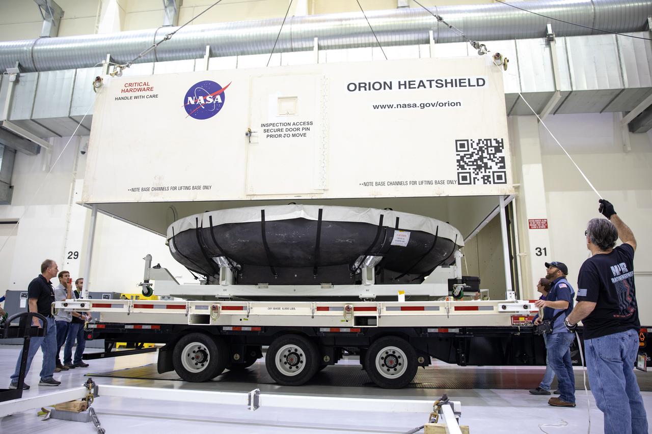 The cover of the shipping container carrying the heat shield for Orion’s Artemis 2 mission, NASA’s first crewed mission, is lifted up inside the Neil Armstrong Operations and Checkout Building high bay at the agency’s Kennedy Space Center in Florida on July 10, 2019. The heat shield, measuring roughly 16 feet in diameter, will protect astronauts upon re-entry on the second mission of Artemis. The heat shield arrived from Lockheed Martin’s manufacturing facility near Denver aboard NASA’s Super Guppy Aircraft. The heat shield is a base titanium truss structure. Over the next several months, technicians will apply Avcoat, an ablative material that will provide the thermal protection. Artemis 2 will confirm all of the spacecraft’s systems operate as designed in the actual environment of deep space with astronauts aboard.