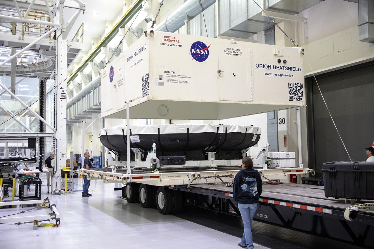 The cover of the shipping container carrying the heat shield for Orion’s Artemis 2 mission, NASA’s first crewed mission, is lifted up inside the Neil Armstrong Operations and Checkout Building high bay at the agency’s Kennedy Space Center in Florida on July 10, 2019. The heat shield, measuring roughly 16 feet in diameter, will protect astronauts upon re-entry on the second mission of Artemis. The heat shield arrived from Lockheed Martin’s manufacturing facility near Denver aboard NASA’s Super Guppy Aircraft. The heat shield is a base titanium truss structure. Over the next several months, technicians will apply Avcoat, an ablative material that will provide the thermal protection. Artemis 2 will confirm all of the spacecraft’s systems operate as designed in the actual environment of deep space with astronauts aboard.