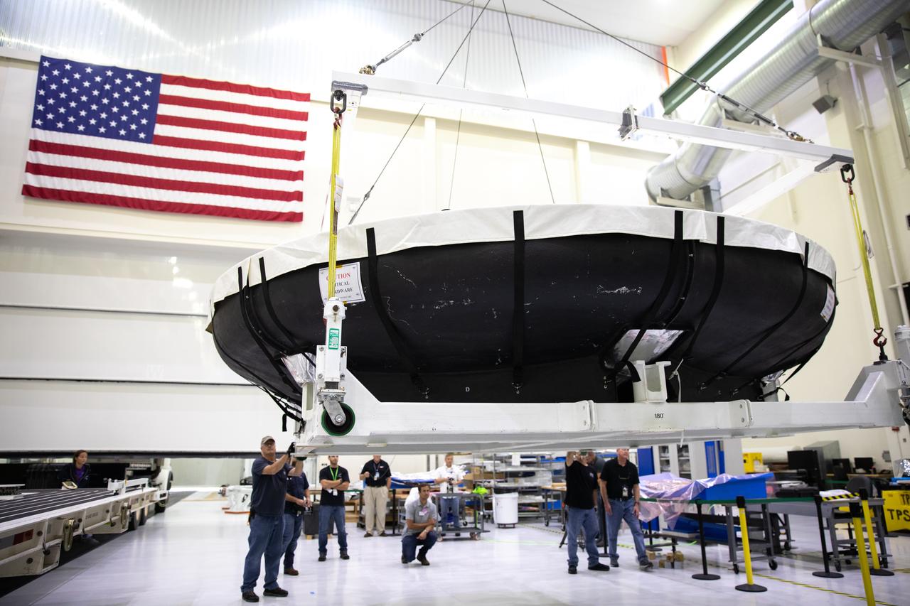 The heat shield for Orion’s Artemis 2 mission, NASA’s first crewed mission, is uncrated in the Neil Armstrong Operations and Checkout Building high bay at the agency’s Kennedy Space Center in Florida on July 9, 2019. The heat shield, measuring roughly 16 feet in diameter, will protect astronauts upon re-entry on the second mission of Artemis. The heat shield arrived from Lockheed Martin’s manufacturing facility near Denver aboard NASA’s Super Guppy Aircraft. The heat shield is a base titanium truss structure. Over the next several months, technicians will apply Avcoat, an ablative material that will provide the thermal protection. Artemis 2 will confirm all of the spacecraft’s systems operate as designed in the actual environment of deep space with astronauts aboard.