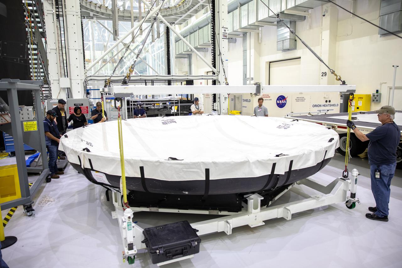 The heat shield for Orion’s Artemis 2 mission, NASA’s first crewed mission, is now uncrated from its shipping container inside the Neil Armstrong Operations and Checkout Building high bay at the agency’s Kennedy Space Center in Florida on July 10, 2019. The heat shield, measuring roughly 16 feet in diameter, will protect astronauts upon re-entry on the second mission of Artemis. The heat shield arrived from Lockheed Martin’s manufacturing facility near Denver aboard NASA’s Super Guppy Aircraft. The heat shield is a base titanium truss structure. Over the next several months, technicians will apply Avcoat, an ablative material that will provide the thermal protection. Artemis 2 will confirm all of the spacecraft’s systems operate as designed in the actual environment of deep space with astronauts aboard.
