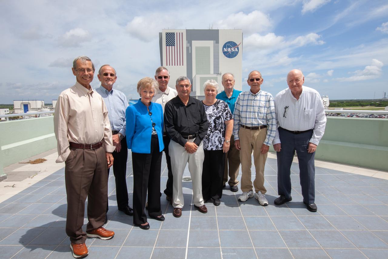 NASA and contractor employees who were working at NASA’s Kennedy Space Center in Florida during the Apollo 11 launch gathered for a group photo on the observation deck of Operations and Support Building II on July 11, 2019. From left, along with their titles from 50 years ago, are Richard Sharum, NASA civil servant; Edward Wilson, security officer for Wackenhut Corporation; Sue Gross, secretary to the deputy procurement officer; Emery Lamar, NASA Kennedy co-op student in Apollo Spacecraft Electrical Division; James Scotti, material clerk with Bendix Corporation; Suzanne Stuckey, secretary for telemetry; Andrew Pritchard, contractor with McGregor-Warner; Ken Poimboeuf, Design Engineering Directorate; and Grady McCorquodale, Launch Control Center engineer with Boeing. Not pictured are Richard Cota, civil servant in the Engineering Directorate; and Victor Kurjack, data courier.