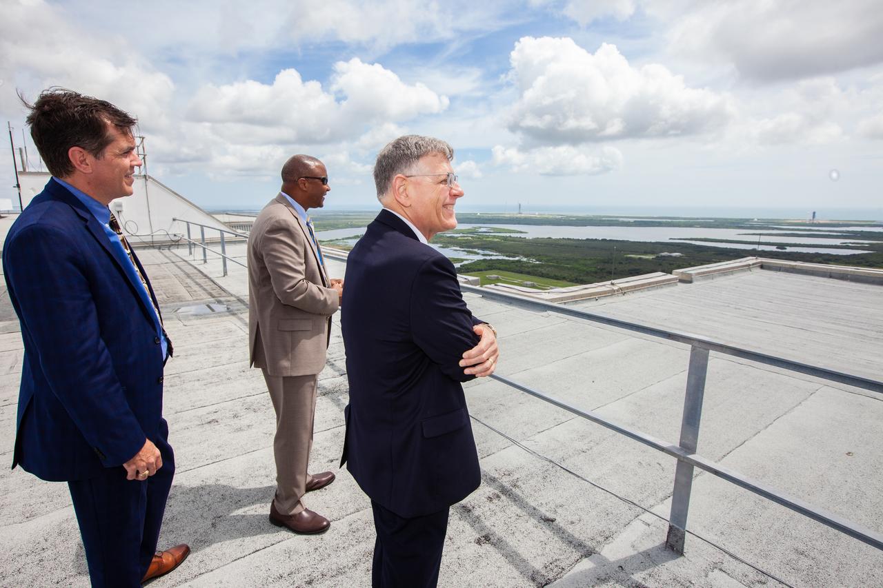 From left to right, NASA Associate Administrator for STEM Engagement Mike Kincade, left, Kelvin Manning, associate director, technical, of NASA’s Kennedy Space Center in Florida, and White House Office of Science and Technology Policy Director Kelvin Droegemeier, right, enjoy a panoramic view from the roof of the Vehicle Assembly Building on July 10, 2019. Droegemeier visited the iconic rocket-assembly facility in the heart of Kennedy’s Launch Complex 39 Area during a tour of the multi-user spaceport.