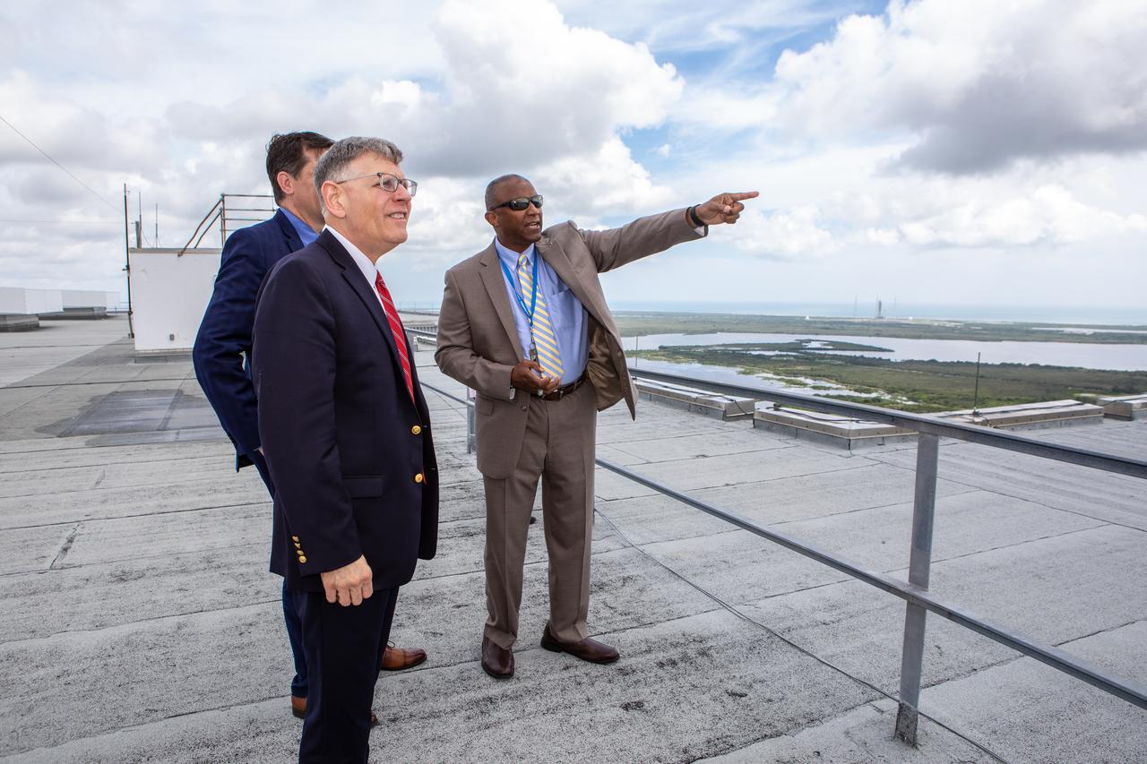 Kelvin Manning, right, associate director, technical, of NASA’s Kennedy Space Center in Florida, points out various landmarks to White House Office of Science and Technology Policy Director Kelvin Droegemeier, center, and NASA Associate Administrator for STEM Engagement Mike Kincade, left, from the roof of the Vehicle Assembly Building on July 10, 2019. Droegemeier visited the iconic rocket-assembly facility in the heart of Kennedy’s Launch Complex 39 Area during a tour of the multi-user spaceport. 
