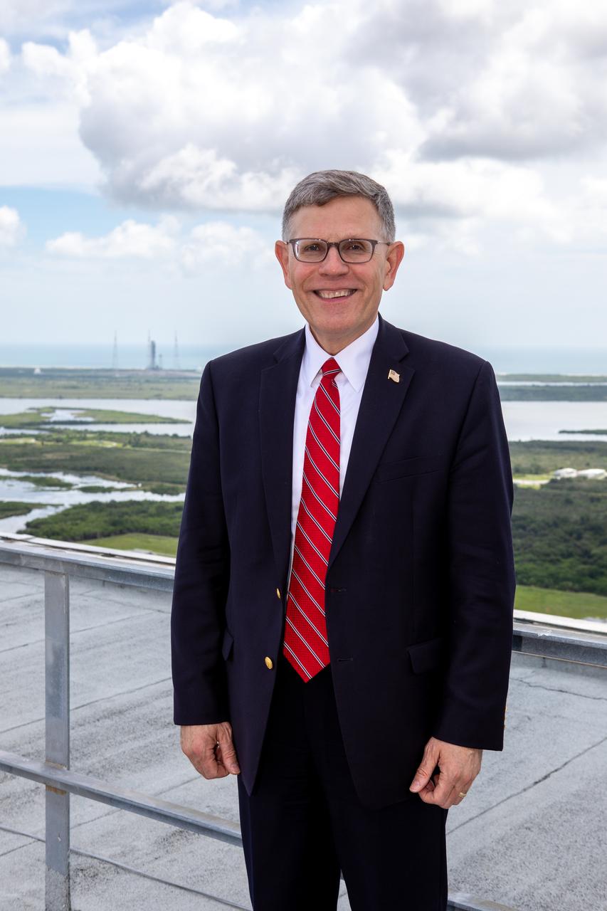 White House Office of Science and Technology Policy Director Kelvin Droegemeier visits the roof of the Vehicle Assembly Building at NASA’s Kennedy Space Center in Florida on July 10, 2019. In the background is Launch Complex 39B, where the mobile launcher is undergoing testing in preparation for launch of the agency’s Space Launch System rocket for the first Artemis mission. Droegemeier visited the iconic rocket-assembly facility in the heart of Kennedy’s Launch Complex 39 Area during a tour of the multi-user spaceport. 