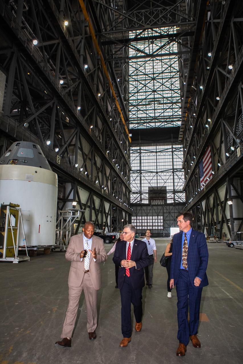 Kelvin Manning, left, associate director, technical, of NASA’s Kennedy Space Center in Florida, speaks to White House Office of Science and Technology Policy Director Kelvin Droegemeier, center, and NASA Associate Administrator for STEM Engagement Mike Kincade, right, inside the transfer aisle of the Vehicle Assembly Building on July 10, 2019, at NASA’s Kennedy Space Center in Florida. Droegemeier visited the iconic rocket-assembly facility in the heart of Kennedy’s Launch Complex 39 Area during a tour of the multi-user spaceport. 