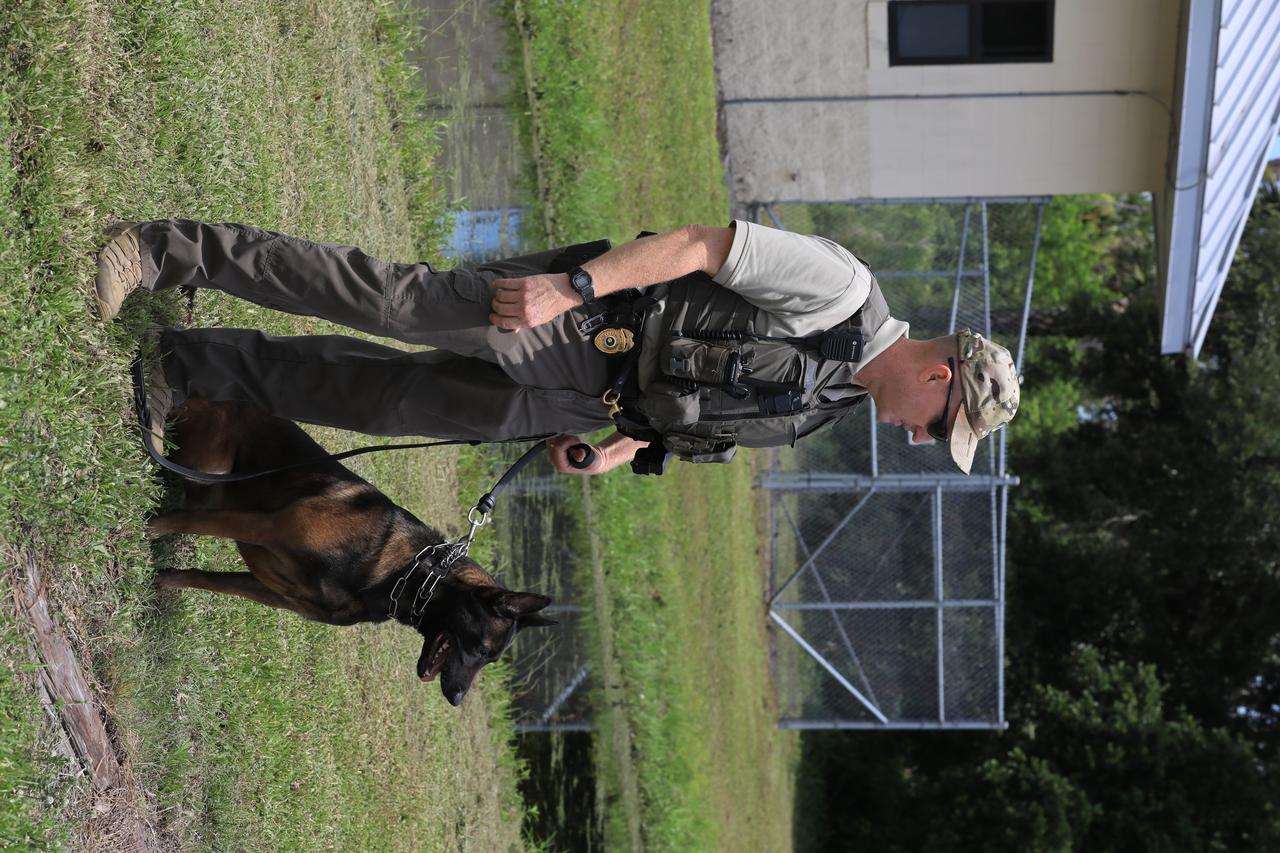 K-9 Spike is ready for the next training exercise with his Handler Officer John McGee at Kennedy Space Center’s Protective Services Office in Florida on July 10, 2019. The center’s specially trained K-9s support the center 24/7, 365 days. Their main goal is to protect the Kennedy workforce and assets. Normal activities include sweeps of designated facilities, parking lots and random vehicle inspections at entrance gates. During rocket launches, they are out and about performing sweeps of facilities and launch site viewing areas. They cover Kennedy and the Merritt Island National Wildlife Refuge.