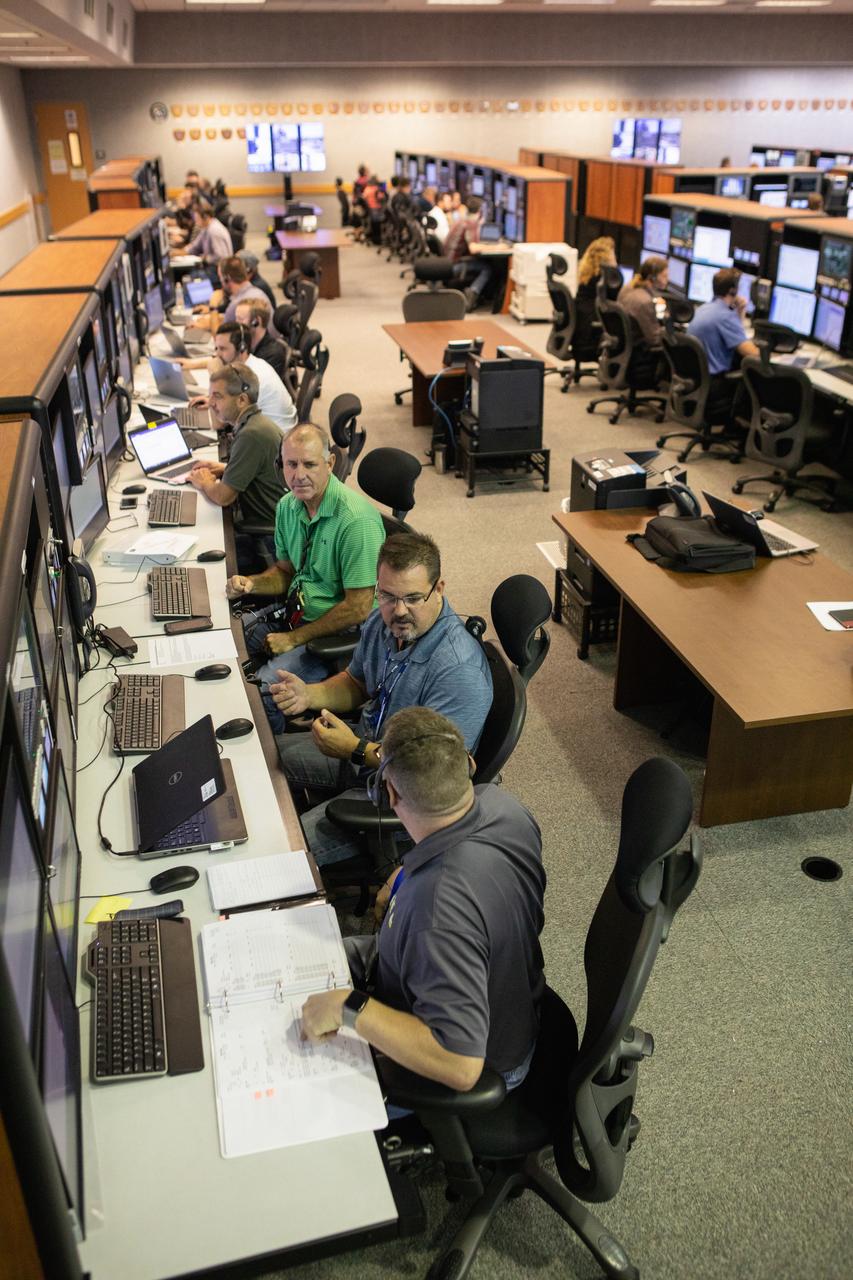 Members of the Artemis 1 launch team, including personnel with NASA’s Exploration Ground Systems (EGS) and Jacobs Test and Operations Contract (TOSC), participate in validation testing inside Firing Room 1 in the Launch Control Center at NASA’s Kennedy Space Center in Florida on July 11, 2019. The team includes personnel with NASA’s Exploration Ground Systems (EGS) and Jacobs Test and Operations Contract (TOSC). The simulation was designed to validate the firing room consoles and communications systems, as well as the new Spaceport Command and Control System (SCCS), which will operate, monitor and coordinate ground equipment in preparation for Artemis 1, the uncrewed first flight of the Space Launch System rocket and Orion spacecraft. 