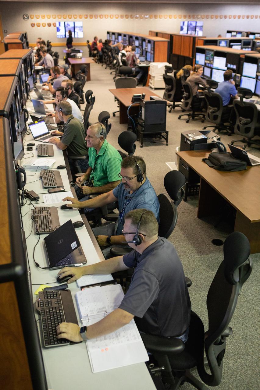 Members of the Artemis 1 launch team, including personnel with NASA’s Exploration Ground Systems (EGS) and Jacobs Test and Operations Contract (TOSC), participate in validation testing inside Firing Room 1 in the Launch Control Center at NASA’s Kennedy Space Center in Florida on July 11, 2019. The team includes personnel with NASA’s Exploration Ground Systems (EGS) and Jacobs Test and Operations Contract (TOSC). The simulation was designed to validate the firing room consoles and communications systems, as well as the new Spaceport Command and Control System (SCCS), which will operate, monitor and coordinate ground equipment in preparation for Artemis 1, the uncrewed first flight of the Space Launch System rocket and Orion spacecraft. 