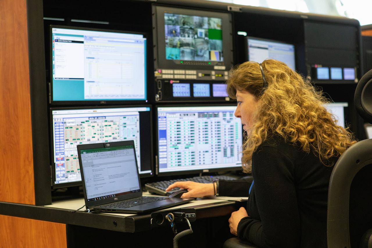 A member of the Artemis 1 launch team participates in validation testing inside Firing Room 1 in the Launch Control Center at NASA’s Kennedy Space Center in Florida on July 11, 2019.  The launch team includes personnel with NASA’s Exploration Ground Systems (EGS) and Jacobs Test and Operations Contract (TOSC). The simulation was designed to validate the firing room consoles and communications systems, as well as the new Spaceport Command and Control System (SCCS), which will operate, monitor and coordinate ground equipment in preparation for Artemis 1, the uncrewed first flight of the Space Launch System rocket and Orion spacecraft. 