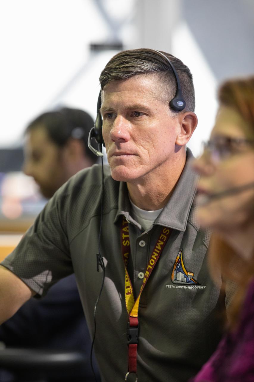 Jeremy Graeber, chief NASA test director, participates in validation testing inside Firing Room 1 in the Launch Control Center at NASA’s Kennedy Space Center in Florida on July 11, 2019.  The Artemis 1 launch team includes personnel with NASA’s Exploration Ground Systems (EGS) and Jacobs Test and Operations Contract (TOSC). The simulation was designed to validate the firing room consoles and communications systems, as well as the new Spaceport Command and Control System (SCCS), which will operate, monitor and coordinate ground equipment in preparation for Artemis 1, the uncrewed first flight of the Space Launch System rocket and Orion spacecraft. 