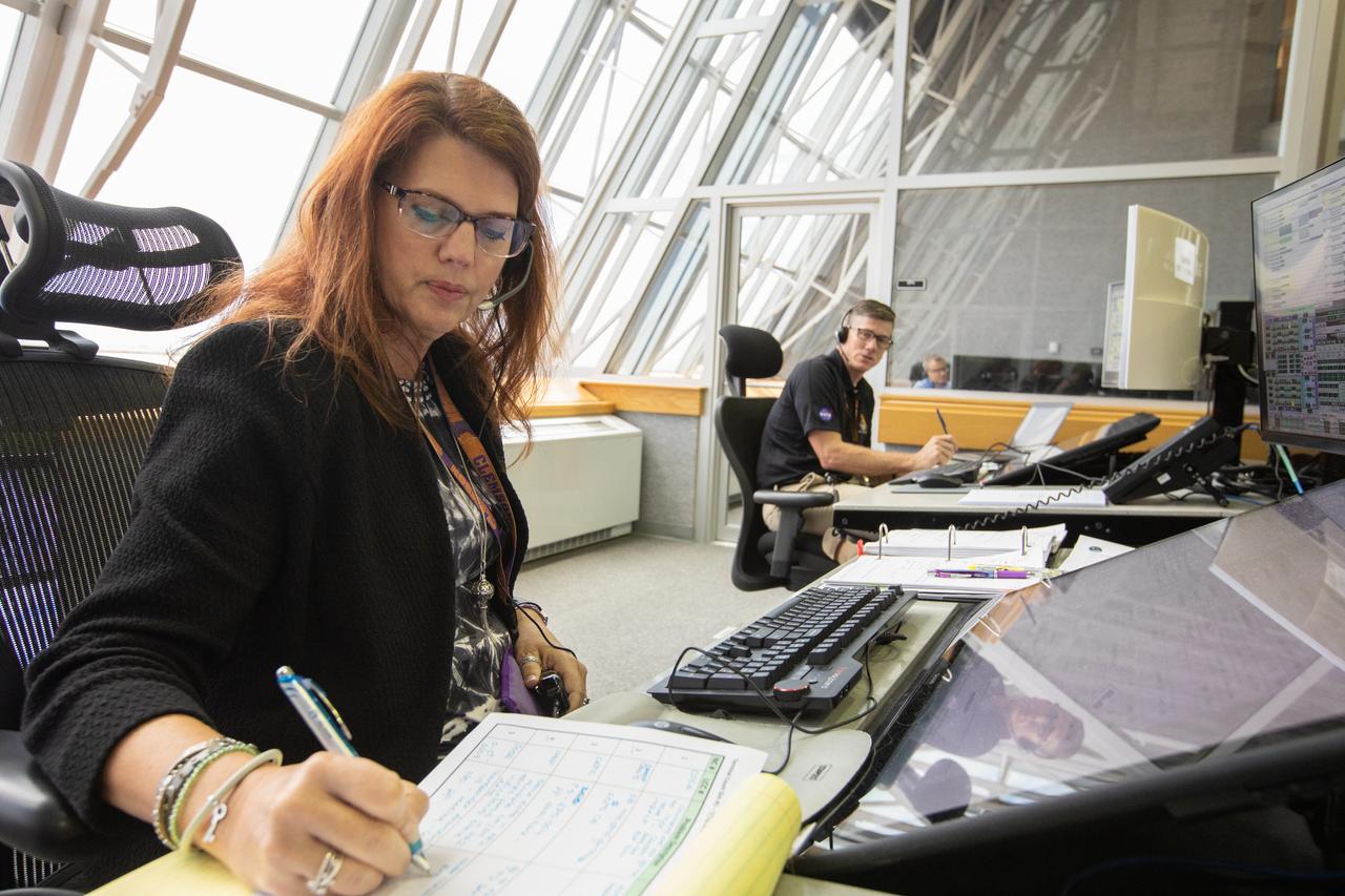 Charlie Blackwell-Thompson, left, launch director for Artemis 1, and Jeremy Graeber, right, chief NASA test director, monitor activities during the first formal terminal countdown simulation inside Firing Room 1 in the Launch Control Center at NASA’s Kennedy Space Center in Florida on July 12, 2019.  This was the first in a series of simulations to help the members of the launch team, including personnel with NASA’s Exploration Ground Systems (EGS) and Jacobs Test and Operations Contract (TOSC), prepare for the launch of Artemis 1, the uncrewed first flight of the Space Launch System rocket and Orion spacecraft. 