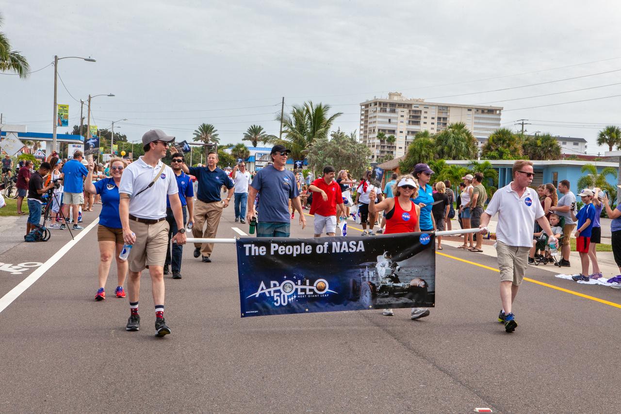 Employees from NASA’s Kennedy Space Center march in the “Man on the Moon” astronaut parade in Cocoa Beach, Florida, on July 13, 2019. The parade was held to honor the 50th anniversary of NASA’s Saturn V/Apollo 11 launch and landing on the Moon.