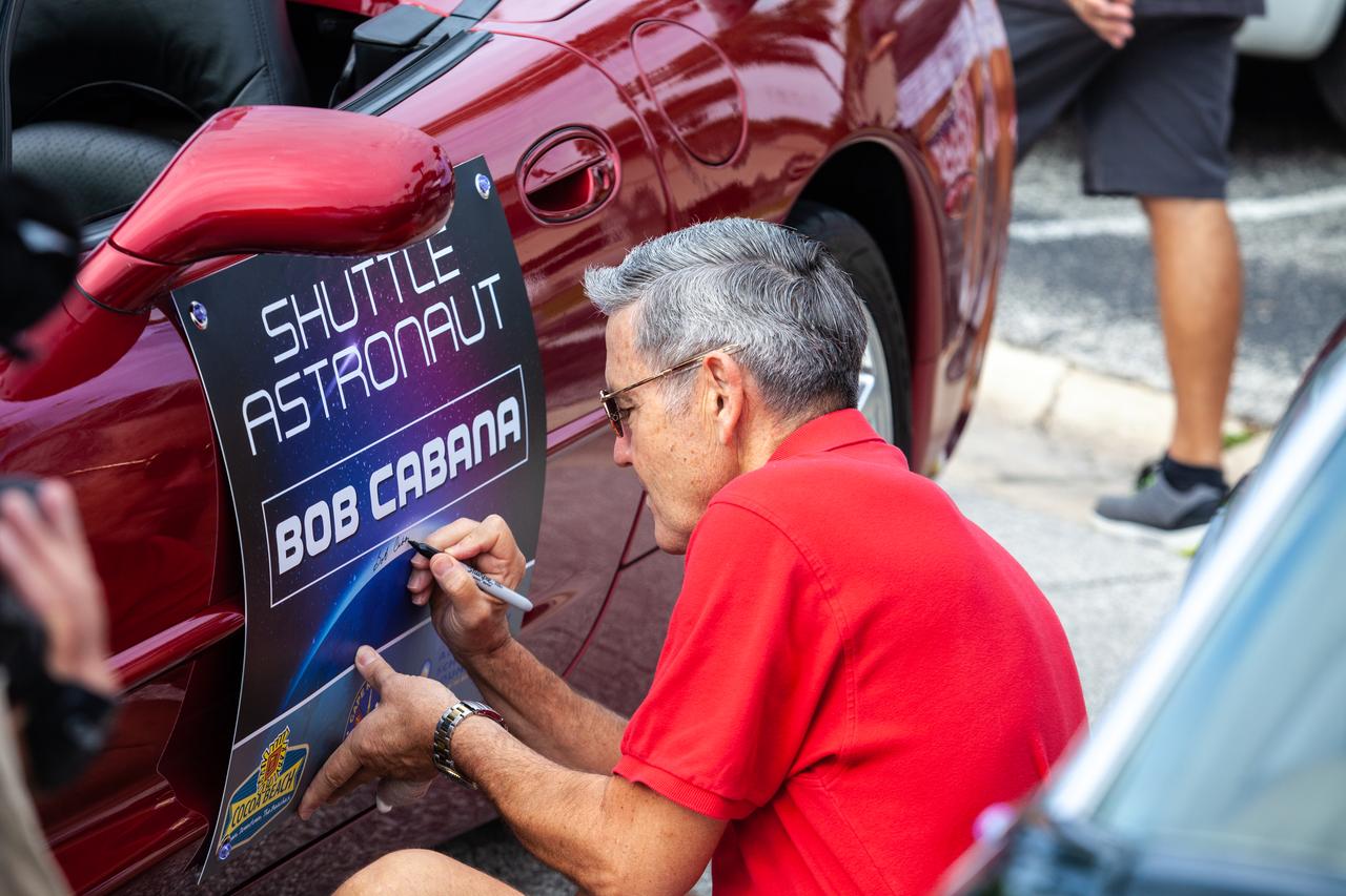 Kennedy Space Center Director and retired NASA astronaut Bob Cabana signs the placard on the Corvette he will ride in the "Man on the Moon" astronaut parade in Cocoa Beach, Florida, on July 13, 2019. The parade was held to honor the 50th anniversary of NASA’s Saturn V/Apollo 11 launch and landing on the Moon. 