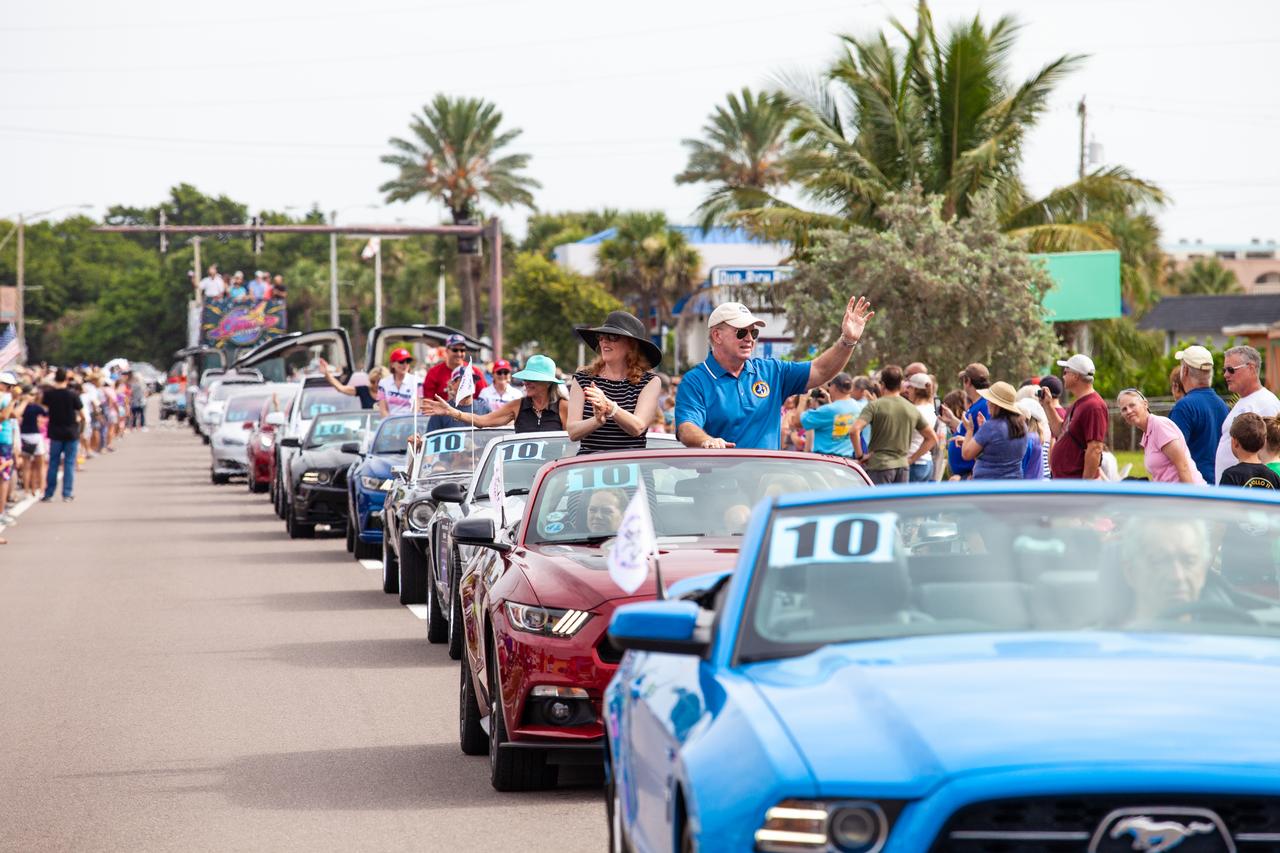 A lineup of Ford Mustangs carry retired space shuttle astronauts and family members of Apollo astronauts during the "Man on the Moon" astronaut parade in Cocoa Beach, Florida, on July 13, 2019. The parade was held to honor the 50th anniversary of NASA’s Saturn V/Apollo 11 launch and landing on the Moon.