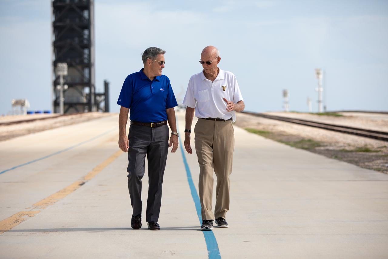 On July 16, 2019, the 50th anniversary of the Apollo 11 launch, astronaut Michael Collins, right, speaks to Kennedy Space Center Director Bob Cabana at Launch Complex 39A. During his visit to the Florida spaceport, Collins discussed the moments leading up to launch at 9:32 a.m. on July 16, 1969, and what it was like to be part of the first crew to land on the Moon. 