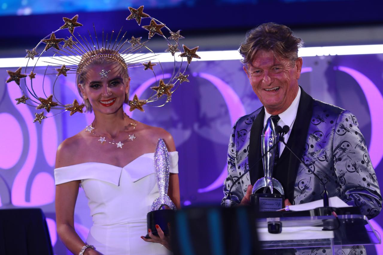 During the Apollo 11 50th Gala, presented by Northrop Grumman, on July 16, 2019, last year's space-themed constume contest winner, left, helps the announcer preent this year's winners their awards. The gala was held inside the Apollo/Saturn V Center at the Kennedy Space Center Visitor Complex in Florida.