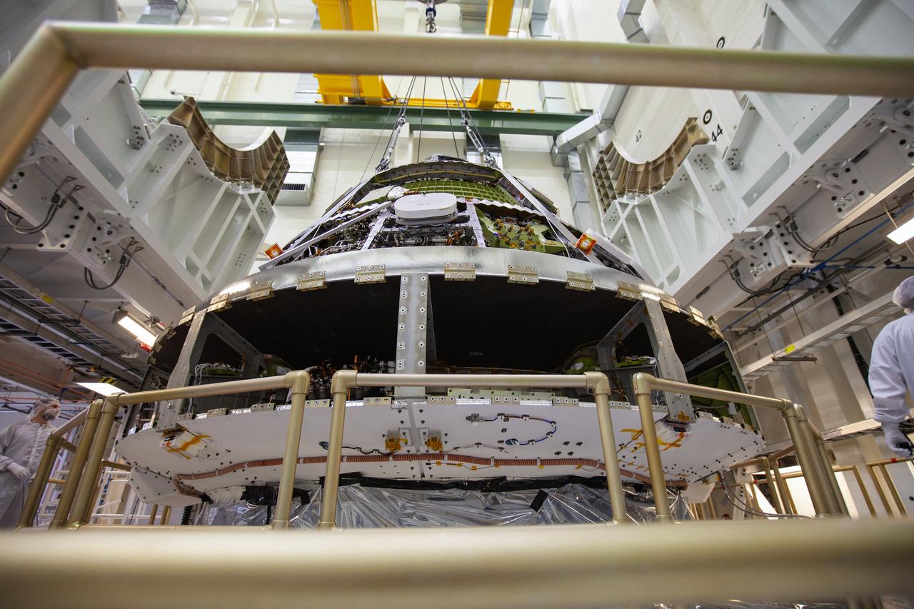 The Orion crew module for Artemis 1 is lifted by crane on July 16, 2019, in the high bay inside the Neil Armstrong Operations and Checkout Building high bay at NASA’s Kennedy Space Center in Florida. The crew module will be moved to the final assembly and test cell and work will begin to secure it atop the service module. The Orion spacecraft is being prepared for its uncrewed test flight atop NASA’s Space Launch System (SLS) rocket. Artemis 1 is the first test flight of the SLS and Orion spacecraft as an integrated system. Orion will travel thousands of miles beyond the Moon during a mission that will test its systems in space. The spacecraft will return to Earth and splashdown in the Pacific Ocean where it will be retrieved and transported back to Kennedy.