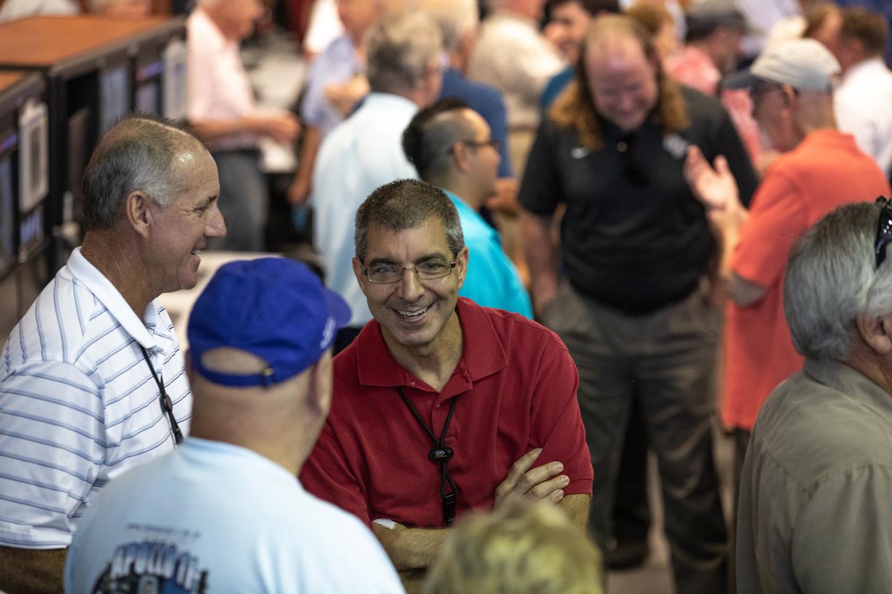 On July 16, 2019, the 50th anniversary of the Apollo 11 launch, Apollo-era and Artemis-1 launch team members mingle in Launch Control Center Firing Room 1 at NASA's Kennedy Space Center in Florida.