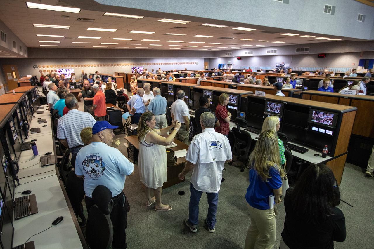 On July 16, 2019, the 50th anniversary of the Apollo 11 launch, Apollo-era and Artemis-1 launch team members mingle in Launch Control Center Firing Room 1 at NASA's Kennedy Space Center in Florida.