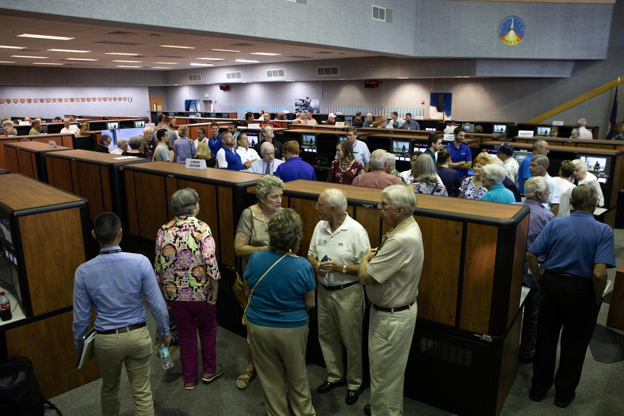 On July 16, 2019, the 50th anniversary of the Apollo 11 launch, Apollo-era and Artemis-1 launch team members mingle in Launch Control Center Firing Room 1 at NASA's Kennedy Space Center in Florida.