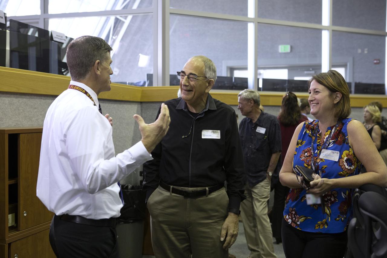 On July 16, 2019, the 50th anniversary of the Apollo 11 launch, Apollo-era and Artemis 1 launch team members mingle in Launch Control Center Firing Room 1 at NASA's Kennedy Space Center in Florida.