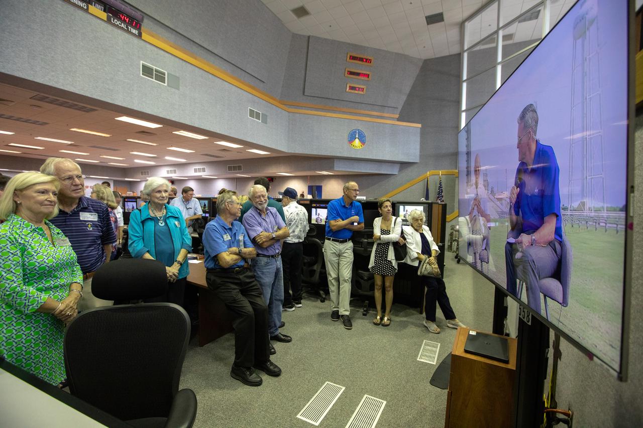 On July 16, 2019, the 50th anniversary of the Apollo 11 launch to the Moon, Apollo-era and Artemis 1 launch team members watch a live broadcast on monitors in Launch Control Center Firing Room 1 at NASA's Kennedy Space Center in Florida. On screen, Kennedy Center Director Bob Cabana is talking with Apollo 11 astronaut Michael Collins at Launch Complex 39A, the site of the Apollo 11 launch. 