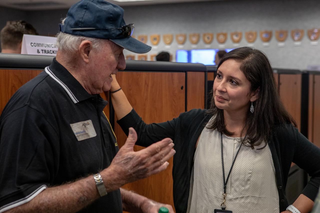 On July 16, 2019, the 50th anniversary of the Apollo 11 launch to the Moon, Jessica Parsons, right, technical assistant to the Artemis 1 launch director, talks with a member of the Apollo 11 launch team in Launch Control Center Firing Room 1 at NASA's Kennedy Space Center in Florida.