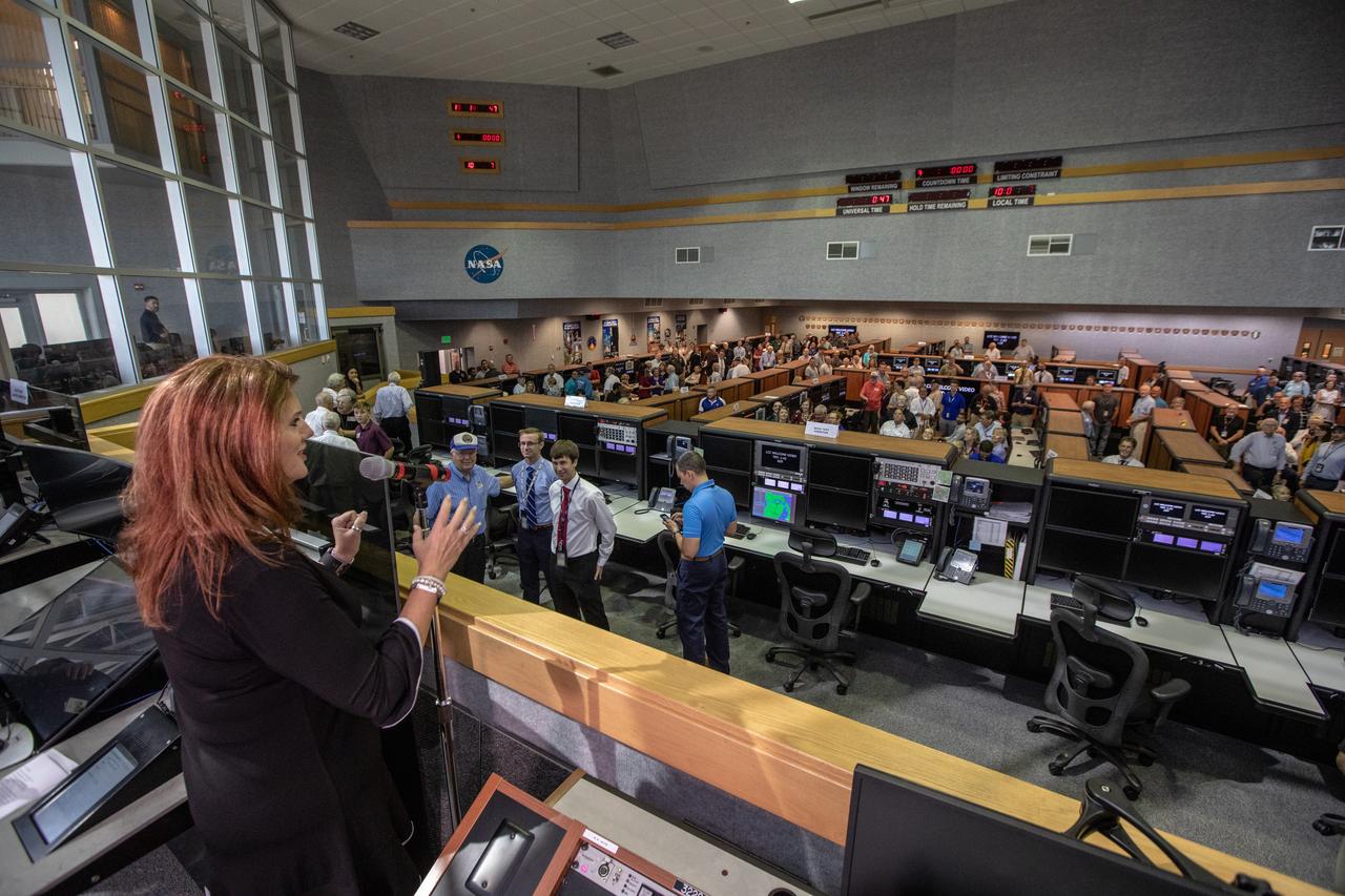 On July 16, 2019, the 50th anniversary of the Apollo 11 launch to the Moon, Artemis 1 Launch Director Charlie Blackwell-Thompson stands in Firing Room 1 in the Launch Control Center at NASA's Kennedy Space Center in Floirda. Apollo 11 and Artemis 1 launch team members mingle in the firing room.