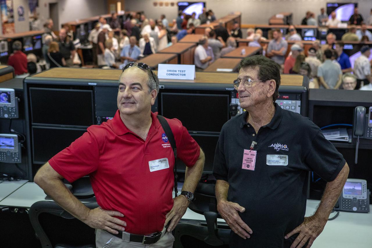 On July 16, 2019, the 50th anniversary of the Apollo 11 launch to the Moon; Apollo-era and Artemis 1 launch team members mingle in Launch Control Center Firing Room 1 at NASA's Kennedy Space Center in Florida.