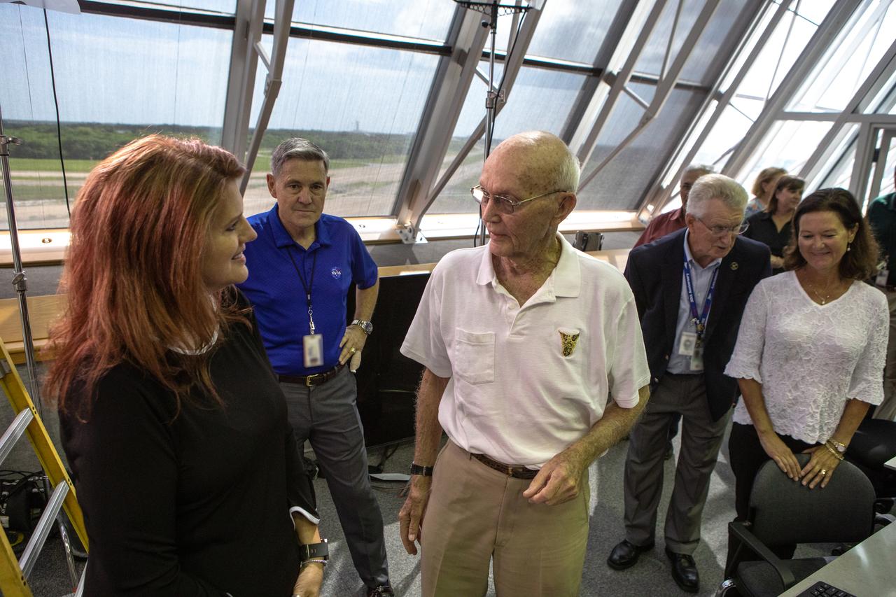 On July 16, 2019, the 50th anniversary of the Apollo 11 launch to the Moon, Apollo 11 and Artemis 1 launch team members mingle in Launch Control Center Firing Room 1 at NASA's Kennedy Space Center in Florida. Artemis 1 Launch Director Charlie Blackwell-Thompson, left, talks to Apollo 11 astronaut Michael Collins. In the background is Kennedy Director Bob Cabana.