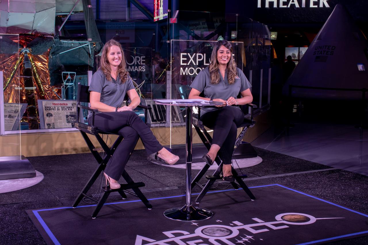 Stephanie Martin, left, NASA Office of Communications, and Nilufar Ramji, NASA Office of STEM Engagement, host a live broadcast of “STEM Forward to the Moon” on July 19, 2019 from Kennedy Space Center’s Apollo/Saturn V Center in Florida. The special program featured kids participating in Moon landing simulations at four museums throughout the country: Cosmosphere in Hutchinson, Kansas; Saint Louis Science Center; Columbia Memorial Space Center in Downey, California; and Arizona Science Center in Phoenix.
