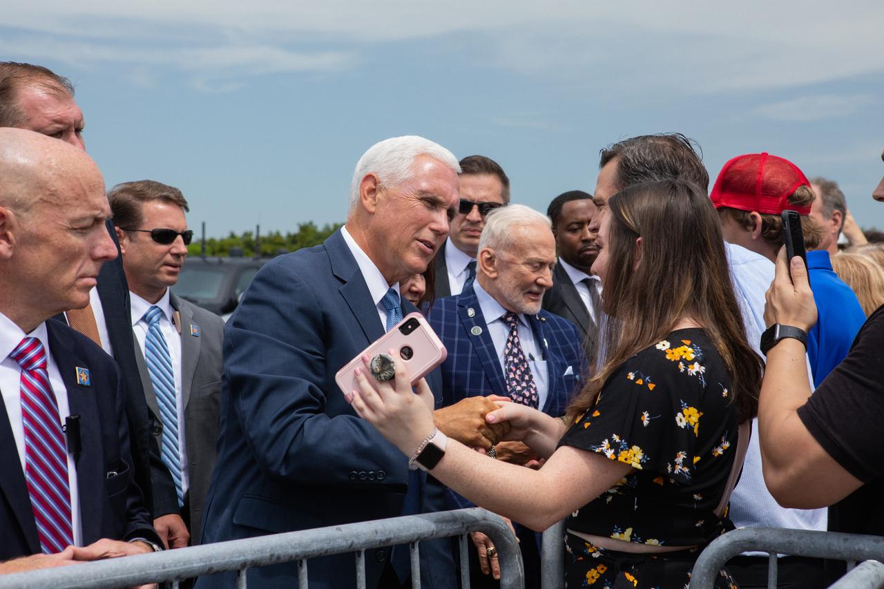 Vice President Pence arrives at Kennedy Space Center's Shuttle Landing Facility on July 20, 2019 and greets workers. At right is Apollo 11 Lunar Module Pilot Buzz Aldrin. Pence, who chairs the National Space Council, visited the Florida spaceport on the 50th anniversary of the Apollo 11 mission, which landed the first two humans on the Moon. He recognized the historic mission, while also addressing NASA’s future plans to travel to the Moon and on to Mars.
